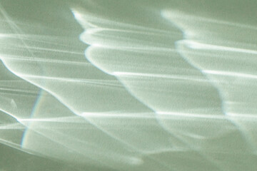 Abstract sunlight shadows mint background with flare and glare. Natural abstract aesthetic mockup with caustic effects for design and presentation.