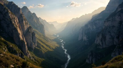 Dramatic sunlit mountain valley with winding river at sunrise or sunset