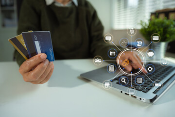 Online payment of hands of women holding smartphone and using credit cards and laptop computers for online shopping.