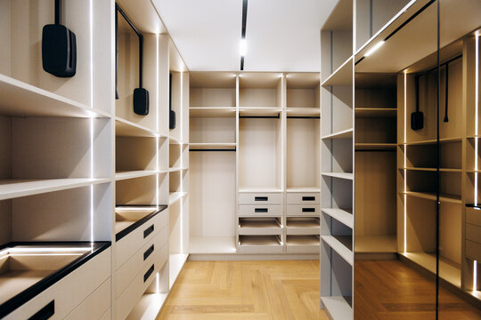 dressing closet with mirror panels and integrated lighting