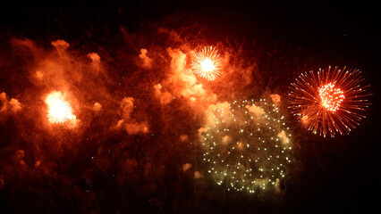 Amazing real beautiful colorful fireworks background on celebration night event for happy new year party, Abstract Multi color golden firework in the night sky