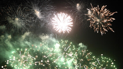 Amazing real beautiful colorful fireworks background on celebration night event for happy new year party, Abstract Multi color golden firework in the night sky