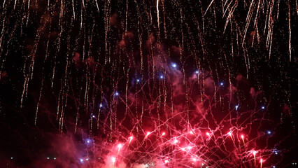 Amazing real beautiful colorful fireworks background on celebration night event for happy new year party, Abstract Multi color golden firework in the night sky