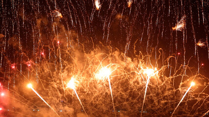 Amazing real beautiful colorful fireworks background on celebration night event for happy new year party, Abstract Multi color golden firework in the night sky