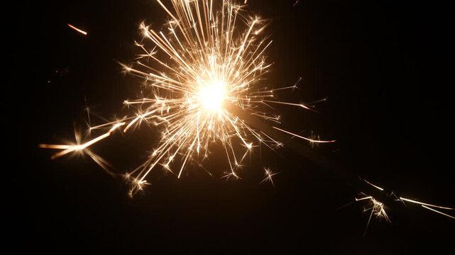 Children set off fireworks in the darkness of the night.