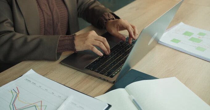 Individual meticulously entering information into digital spreadsheet