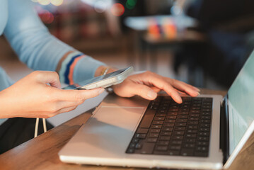 Business woman hands using laptop and smartphone for online customer service, contact us form, tax payment, bill pay, or account support.,concept for fintech, service apps, and websites