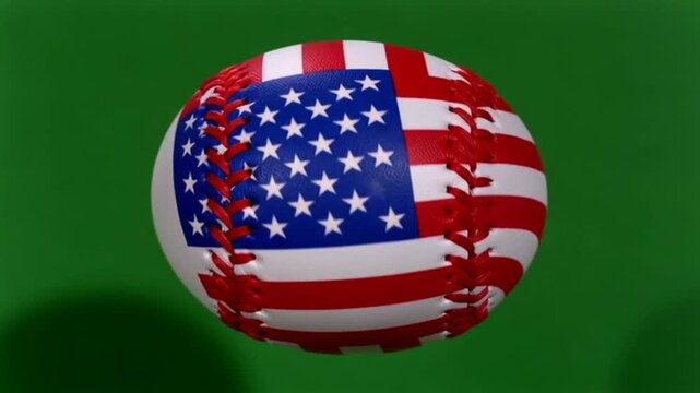 A baseball with the american flag design on it against a green background in close up view