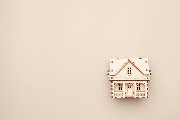 Wooden house model with blank copy space for mortgage loan advertising or real estate offer.