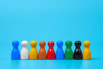Colorful wooden figures in line: Diversity, inclusion, and teamwork concept