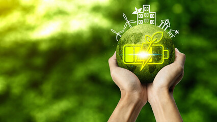 Hands holding a glowing green globe with a battery and leaf icon, surrounded by outlines of wind turbines and eco buildings, representing bio energy and sustainable living. Concept of Bio Energy