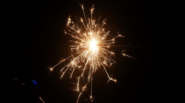 Children set off fireworks in the darkness of the night.