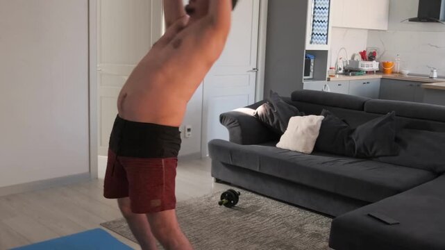 active home workout, white male doing lively cardio at home, man performing highenergy household cardio routine with enthusiasm, an energetic white man engaging in vigorous home cardio exercises