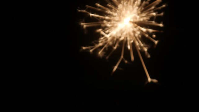 Children set off fireworks in the darkness of the night.