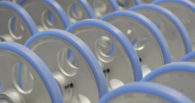 The conveyor is working, the rollers are rotating. Handheld shot, real time speed, artificial lighting.
