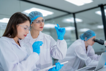 Scientists conduct research in a modern laboratory setting during the day with focus on sample analysis and data collection