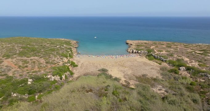 Aerial view of Cala Mosche (or Calamosche) beach, a beautiful sandy beach within the Vendicari Nature Reserve, in province of Syracuse, Sicily, Italy. It's famous for its crystal clear and blue sea.