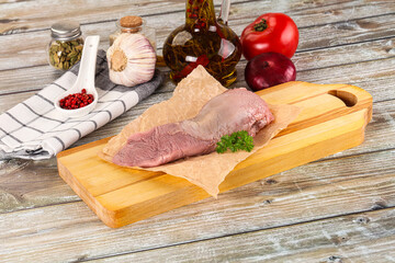 Raw pork tongue over board