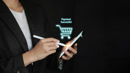 Businesswoman using smartphone with Payment Successful text and cart hologram.
