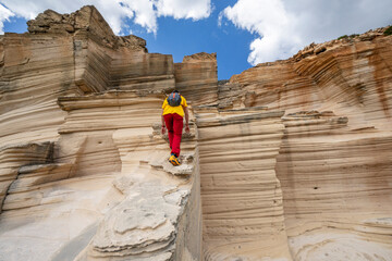 hiker visiting Sandstone quarry near Olla de Bastons, Santanyi, Mallorca, Spain