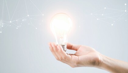 Hand drawing lightbulb in air with glowing trail, dark background, concept of idea and inspiration, cinematic lighting