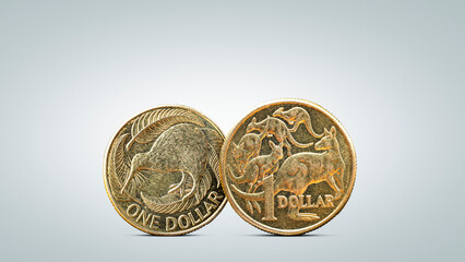 Australian Dollar Coin Next to New Zealand Dollar Coin on Neutral Background