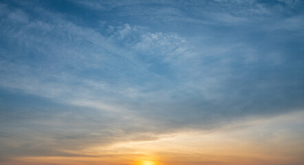 Soft sunrise sky with clouds and warm morning light in a peaceful atmosphere.