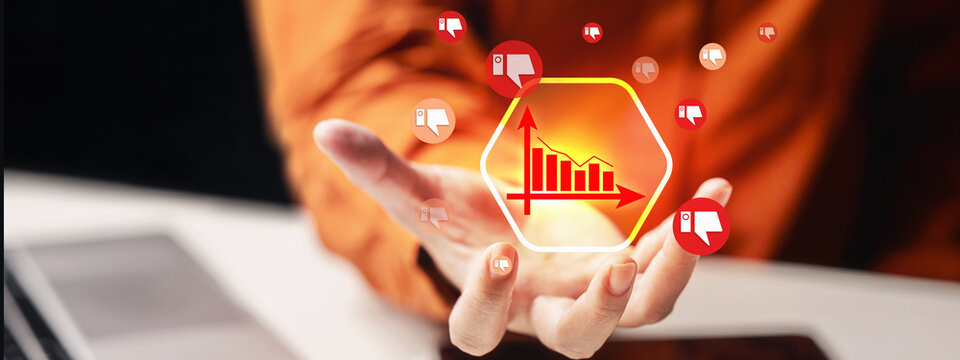 Declining chart with thumbs down icons, symbolizing negative feedback or performance, presented on a human hand. Concept of Public trust