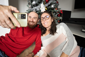 Couple Taking a Selfie with Their Christmas Tree