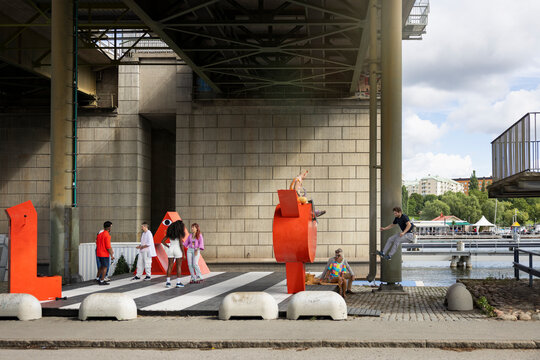 Group of friends spending leisure time under bridge