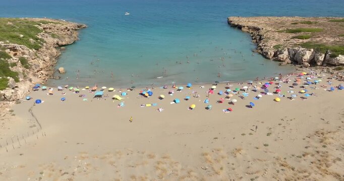 Aerial closeup of Cala Mosche (or Calamosche) beach, a beautiful sandy beach within the Vendicari Nature Reserve, near Noto, Sicily, Italy. It's famous for its crystal clear and blue waters. Sunny day