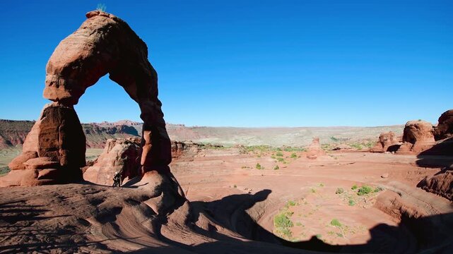 Delicate Arch with tourists at sunrise, Arch National Park