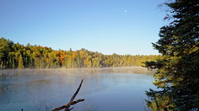 Cinematic wide landscape shot of the Au Sable River in morning mist.