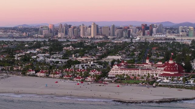 The Hotel del Coronado in San Diego, California, aerial drone shot with the San Diego Skyline in the background.