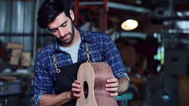 Luthier making top of guitar using traditional tools in workroom with manual tools, arts and craft concept.	
