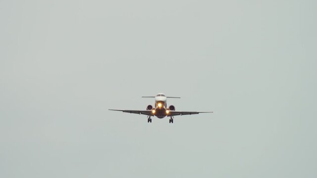 Passenger plane banking during landing approach. Aircraft banking dangerously while descending in cloudy weather. Risk of instability during critical landing phase