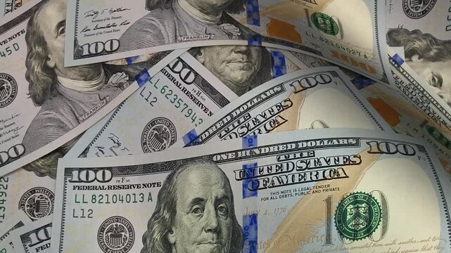 Crisp macro-style movement across textured waves of hundred dollar bills with intricate banknotes that reinforce investment narratives and project an exclusive financial identity centered on cash asse