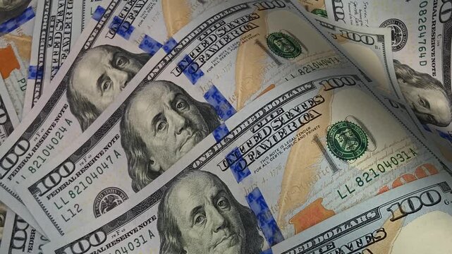 Professional aerial-like movement over patterned waves of hundred dollar bills showcasing banknote textures that symbolize investment strength and deliver an exclusive cash-inspired financial mood
