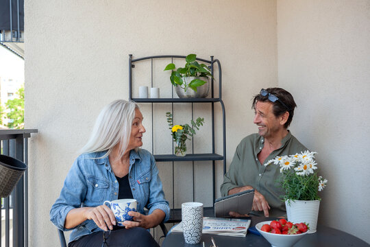 Happy mature couple spending leisure time with each other in balcony