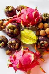 Set of tropical fruit on white wooden table , top view