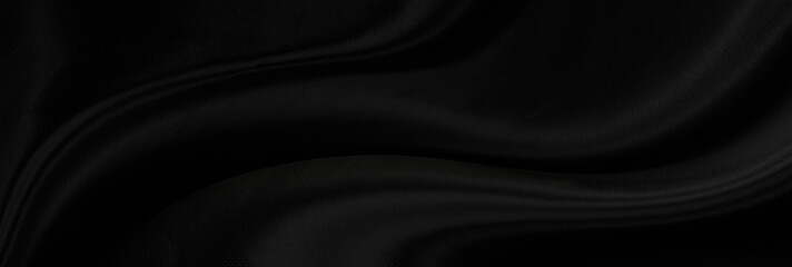 Black gray satin dark fabric texture luxurious shiny that is abstract silk cloth panorama background with patterns soft waves blur beautiful.