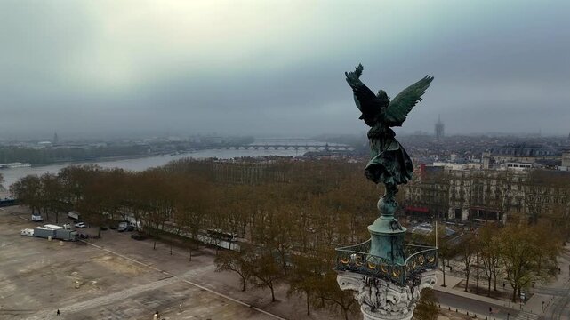 Cinematic drone close up of the bronze Liberty angel statue atop Monument aux Girondins