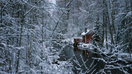 Finland. Small Red Cabin in Winter Forest
