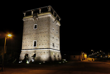 St. Michael's Tower on the canal port of the city Cervia illuminated at night. Ravenna Italy.