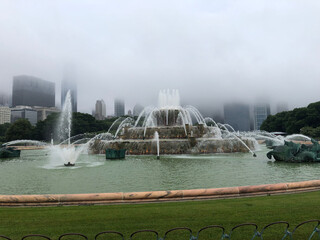 Fountain with Misty Mountains and Foggy Landscape Background