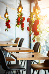 A beautifully designed restaurant interior showcasing a modern and elegant dining area. The space features contemporary furniture, including wooden chairs and tables set with glassware, plates.