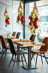 A beautifully designed restaurant interior showcasing a modern and elegant dining area. The space features contemporary furniture, including wooden chairs and tables set with glassware, plates.
