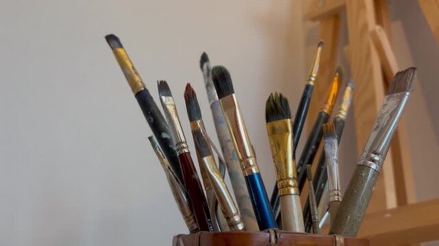 Close up artistic paintbrush in artist studio slow motion. Brushes for oil and watercolor painting