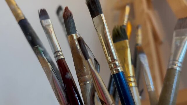 Close up artistic paintbrush in artist studio slow motion. Brushes for oil and watercolor painting