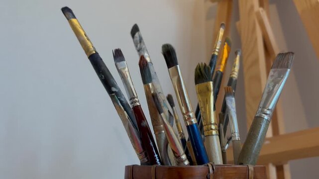 Close up artistic paintbrush in artist studio slow motion. Brushes for oil and watercolor painting